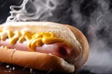 closeup-hot-dog-with-steamy-bun-juicy-meat-foreground_124507-125351-1555491954