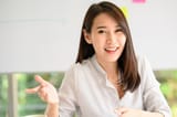 smiling-asian-woman-explaining-something-camera_34840-742