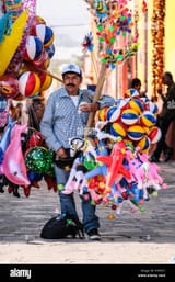 a-male-mexican-balloon-seller-with-many-colorful-balloons-at-a-plaza-KYRCE7-915112047