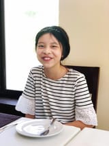 portrait-smiling-girl-sitting-restaurant-table_1048944-4755509-824450208