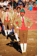 a-bullfighter-forcado-in-traditional-costume-stands-and-provokes-a-C7TB9T-3195332372