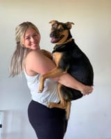 Ellana_white_dog_carry_smile_grown_dog