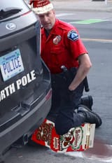 santa chauvin kneels on a nog
