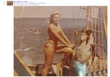 hot mother from 1991 in a bikini on a boat with a collie