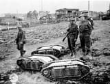 British-soldiers-with-captured-German-Goliath-tracked-mines.