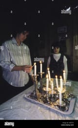 hanukkah-candles-being-lit-in-an-orthodox-jewish-family-home-in-stamford-AGE576