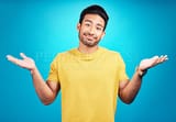 2693470-confused-question-and-portrait-of-man-shoulder-shrugging-and-raise-arms-isolated-in-a-blue-studio-background.-clueless-smile-and-young-male-person-with-doubt-whatever-and-doing-a-hand-gesture-fit_400_400
