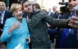 A-refugee-takes-a-selfie-with-German-Chancellor-Angela-Merkel-outside-a-refugee-camp-near
