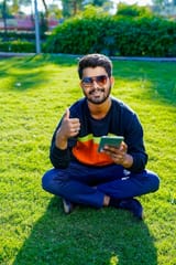 young-indian-man-using-smart-phone-park_621325-267