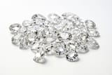 pile-of-diamonds-on-white-background-photo