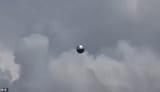 99358817-14810919-A_mysterious_metallic_sphere_was_captured_soaring_above_a_field_-m-20_1749845600864