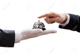 93312995-close-up-of-person-s-hand-ringing-service-bell-held-by-waiter-on-white-background
