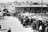 1280px- Auschwitz Birkenau_a_group_of_Jews_walking_towards_the_gas_chambers_and_crematoria in May-June 1944. Gate on the left leads to area BI, the oldest part of the camp
