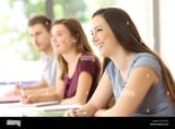 three-attentive-students-listening-to-a-lesson-in-a-classroom-JPTDXN-484795257