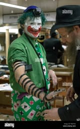 an-orthodox-rabbi-puts-phylacteries-on-a-jewish-new-york-city-character-FWGTXK