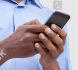 stock-photo-typing-a-message-cheerful-black-man-typing-something-on-the-mobile-phone-and-smiling-while-166727552-1400880803~2