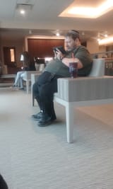 uglyjewonbenchlookingatdevice