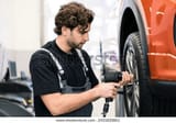 car-mechanic-workshop-changing-tire-600w-2431820861_result