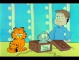 Garfield boxing up Nermal for a trip to Abu Dhabi