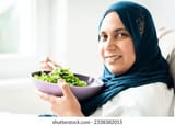 muslim-woman-hijab-eating-her-260nw-2338382015