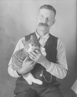 man-wth-a-cat-100-years-ago