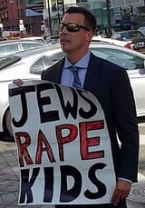 Man_holds_hateful_sign_in_Beverly_Hills_(cropped)