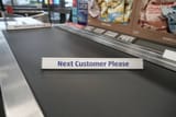 tarleton-united-kingdom-shopping-sits-on-a-checkout-conveyor-belt-at-the-new-tarleton-aldi
