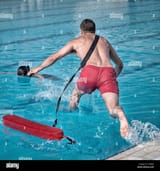 lifeguard-rushes-into-the-pool-T23BGP
