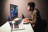 program-development-concept-young-indian-man-working-with-computer_231208-3642