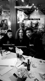italian mutts 1 - Black-and-white photo of three people at a table in a restaurant