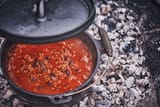 cooking-chili-con-carne-in-dutch-oven-over-logfire