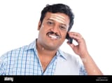 south-indian-man-talking-on-a-mobile-phone-DFPXYC