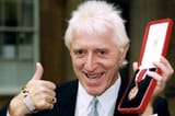 Sir-Jimmy-Savile-after-he-received-his-knighthood-from-Queen-Elizabeth-II-357376473