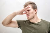 113202303-young-man-keeps-nose-closed-he-smells-bad-smell-isolated-on-white-background