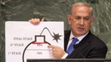 benjamin-netanyahu-perdana-menteri-israel-menggunakan-diagram-bom-untuk-menggambarkan-program-nuklir-iran-afp-via-getty-images_169-3263174179