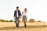 young-White-man_young-White-woman_field-of-hay_harvest