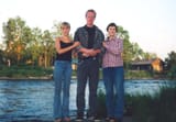 Chud with girlfriends in Russia - Man and two women standing next to each other in front of a river