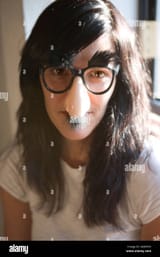 woman-wearing-silly-groucho-marx-mask-with-big-nose-eye-glasses-and-AG6N5N-3316156813