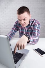 serious-angry-businessman-typing-on-600nw-1324979174