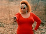 pink-flamingos-1972-002-divine-red-dress-pointing-gun-00n-5bo-1000x750