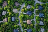 aerial-view-of-suburban-neighborhood-with-houses-nestled-among-lush-green-trees-and-winding-roads-photo