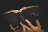 young-woman-person-hand-holding-holy-bible-with-study-at-home-adult-female-christian-reading-book-in-church-girl-learning-religion-spirituality-with-pray-to-god-concept-of-student-education-faith-photo