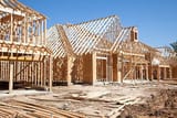 new-homes-construction-site-framed-houses-lumber-building