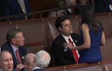 AOC sits