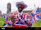 joseph-afrane-in-union-jack-flag-british-suiton-brexit-day-31-january-2020-in-london-uk-patriotic-outfit-black-male-in-red-white-and-blue-2ATBERW