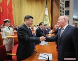 Xi awards Klaus with honor in front of CCP Politburo