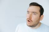 man-expressing-surprise-minimalist-indoor-environment-daytime-man-displays-look-shock-disbelief-wide-390322173