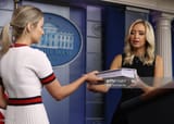 white-house-press-secretary-kayleigh-mcenany-is-handed-her-notebook-picture-id1257420378