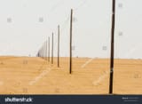 stock-photo-telegraph-poles-beside-a-road-stretch-out-as-far-as-you-can-see-showing-the-curvature-of-the-earth-1472172746