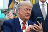 president-donald-trump-silences-his-mobile-phone-which-rang-two-times-as-he-was-speaking-to-reporter